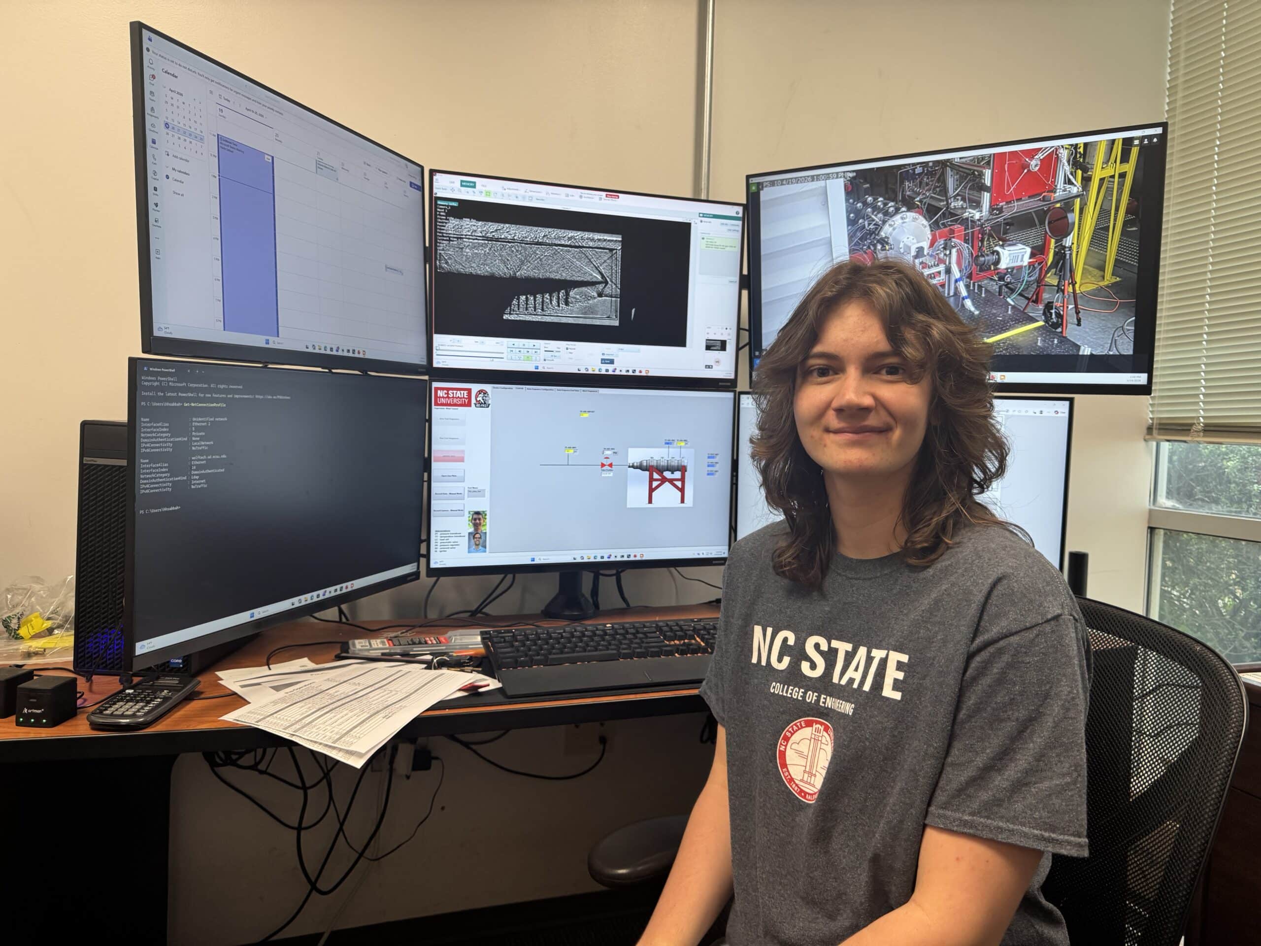 Hannah Reeves-Cowell sitting in front of monitors in the BEFAST Lab.
